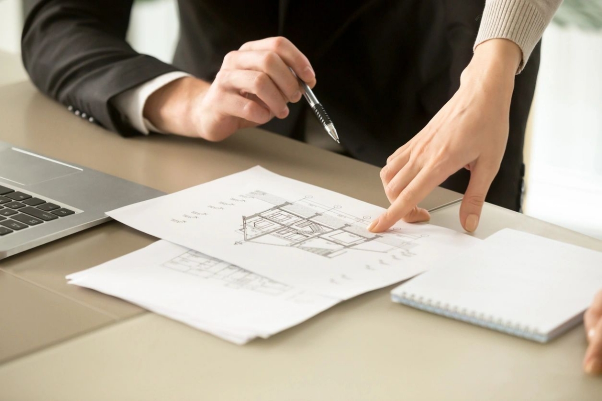 Two professionals reviewing an industrial lease document in a San Fernando Valley warehouse office