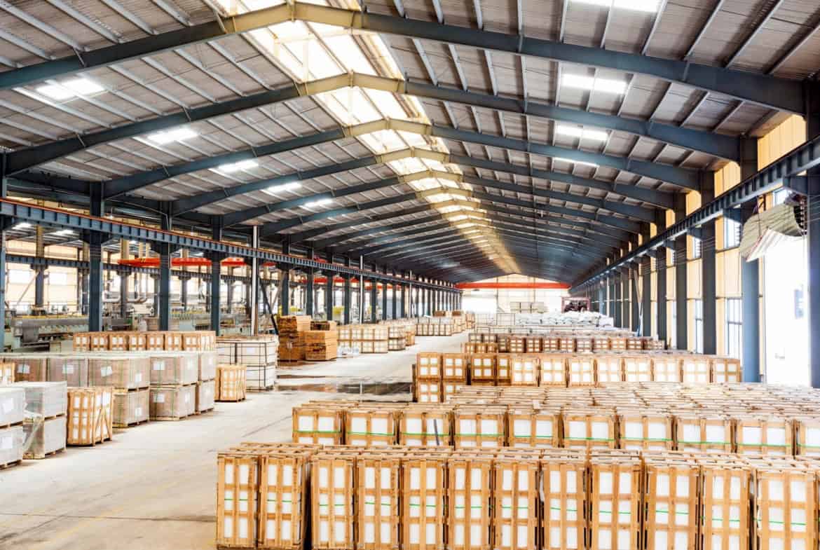 Interior of a San Fernando Valley industrial warehouse with rows of palletized goods, high clear height, and skylights